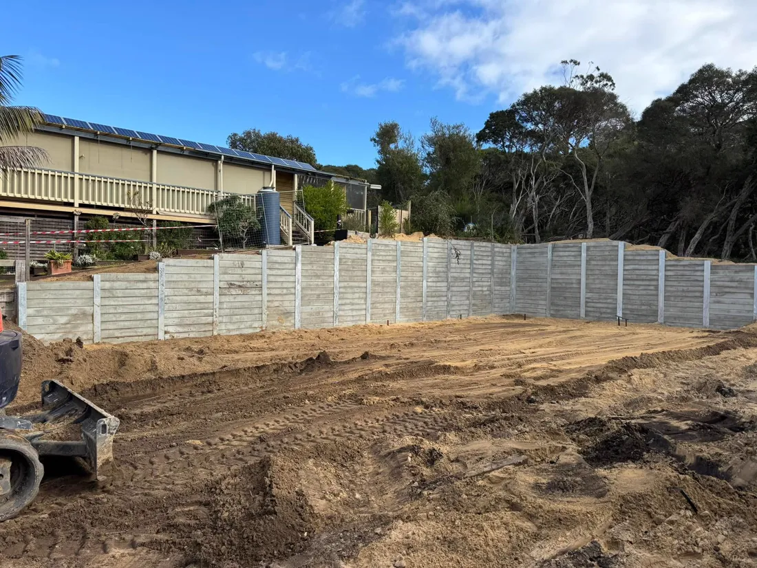 Tidy grey sleeper retaining wall