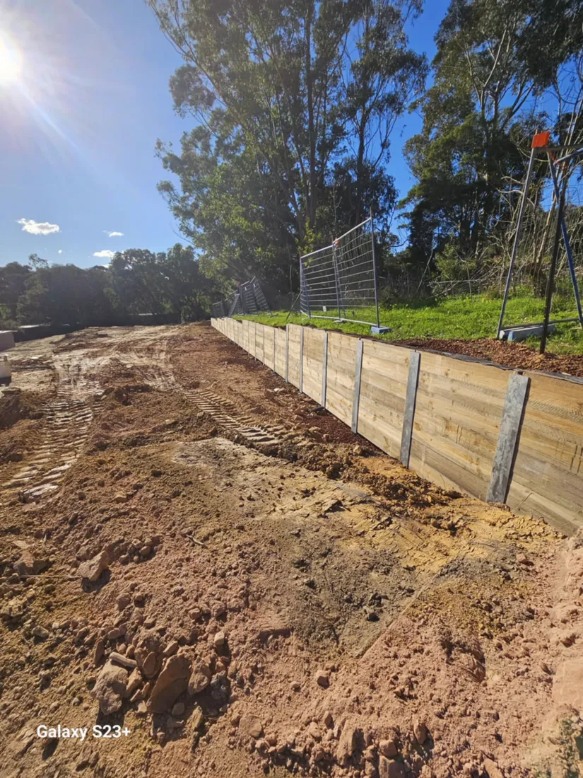Timber sleeper retaining wall under construction